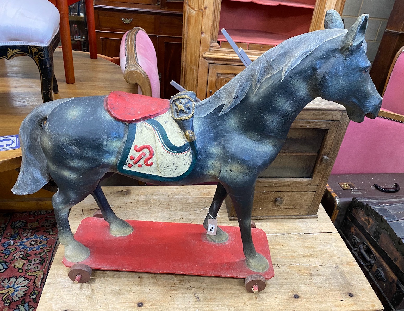 A 1930's German moulded and painted composition pull-along horse, height 96cm